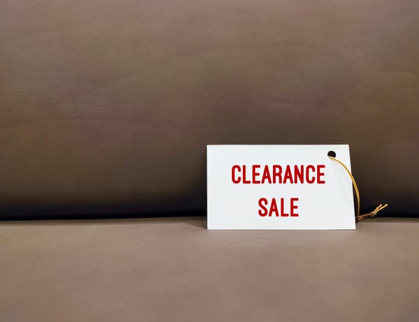 A clearance sale tag against a brown background